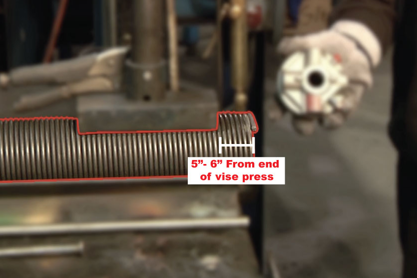 Extend the spring 5 to 6 inches from the end of the vise press