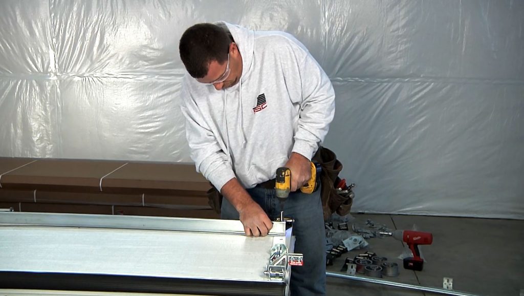 Garage door technician prepping the commercial garage door for install.