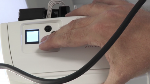 Image of garage door technician setting the travel of the Marantec Synergy 380 Operator.