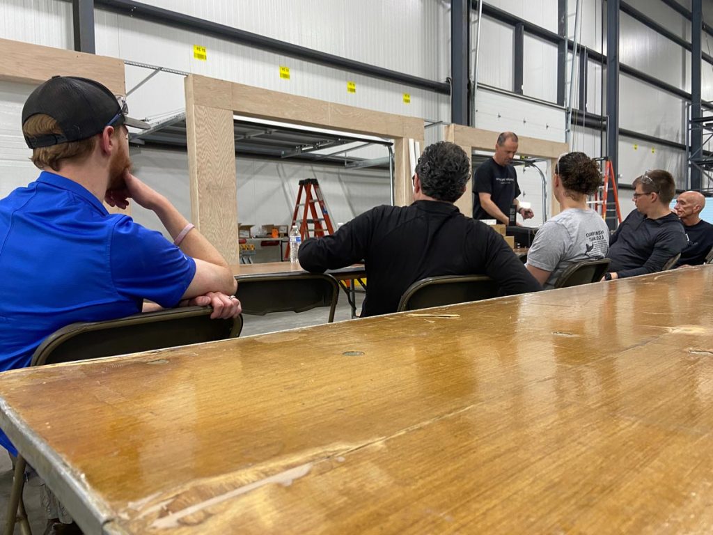 David Mount reviewing the garage door install process with the team before installing.