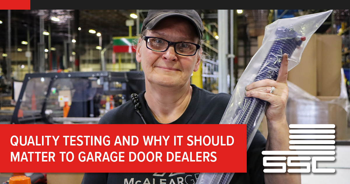 A warehouse worker wearing glasses and a cap smiles while holding a large, purple garage door spring encased in protective plastic. A red banner across the bottom reads, "QUALITY TESTING AND WHY IT SHOULD MATTER TO GARAGE DOOR DEALERS," with the SSC logo in the bottom right corner.